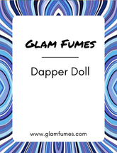 A bottle of perfume and body oil labeled 'Glam Fumes Dapper Doll' with a blue and purple striped pattern in the background.
